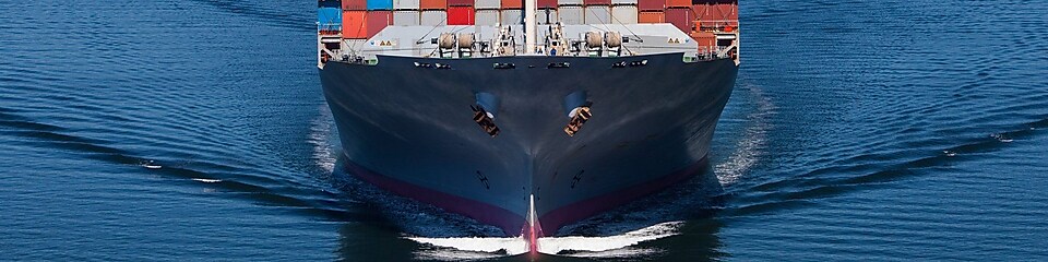 Blue ship wiht containers on it.