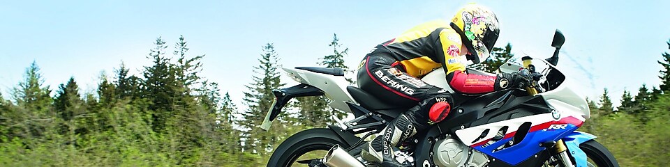 Man riding a motorbike along country road