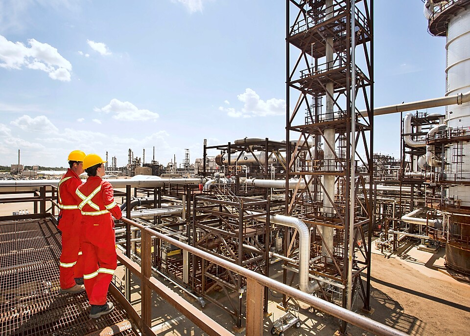 Workers survey a portion of the Quest unit at the Scotford