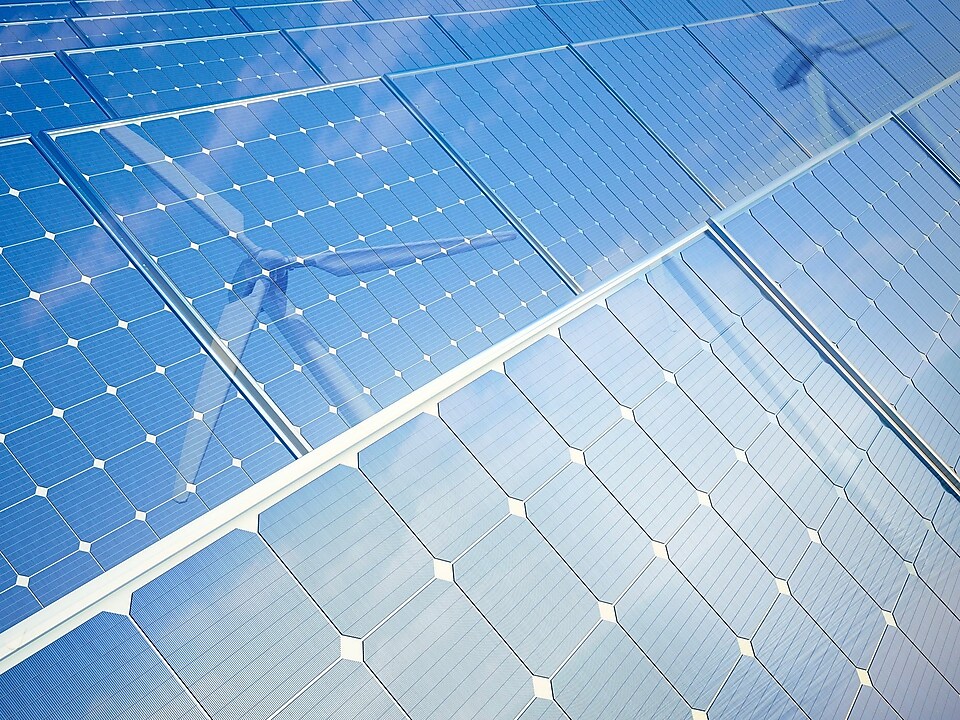 Photovoltaic panels and wind turbines, computer illustration.